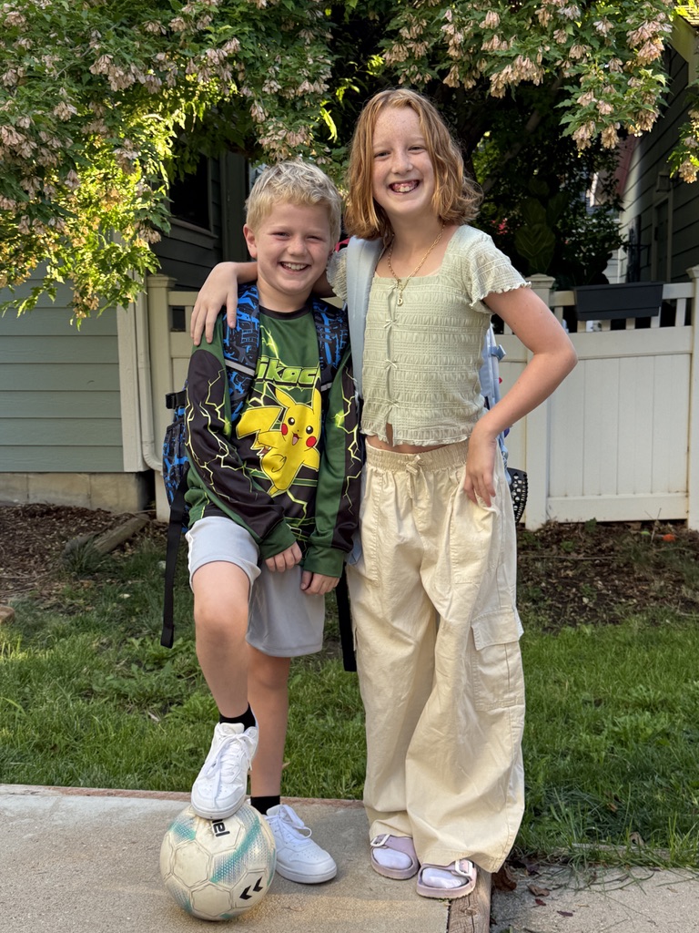 Jackson and Delila together under a flowering tree in golden light